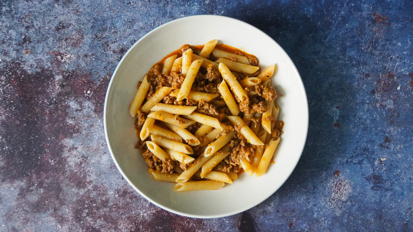 Penne Pasta in a bowl with Beef Bolognese sauce
