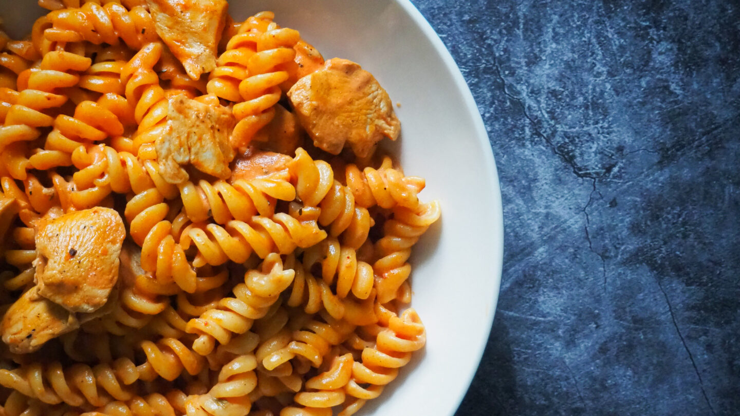 Bowl of creamy cajun spiced chicken cubes with fusilli