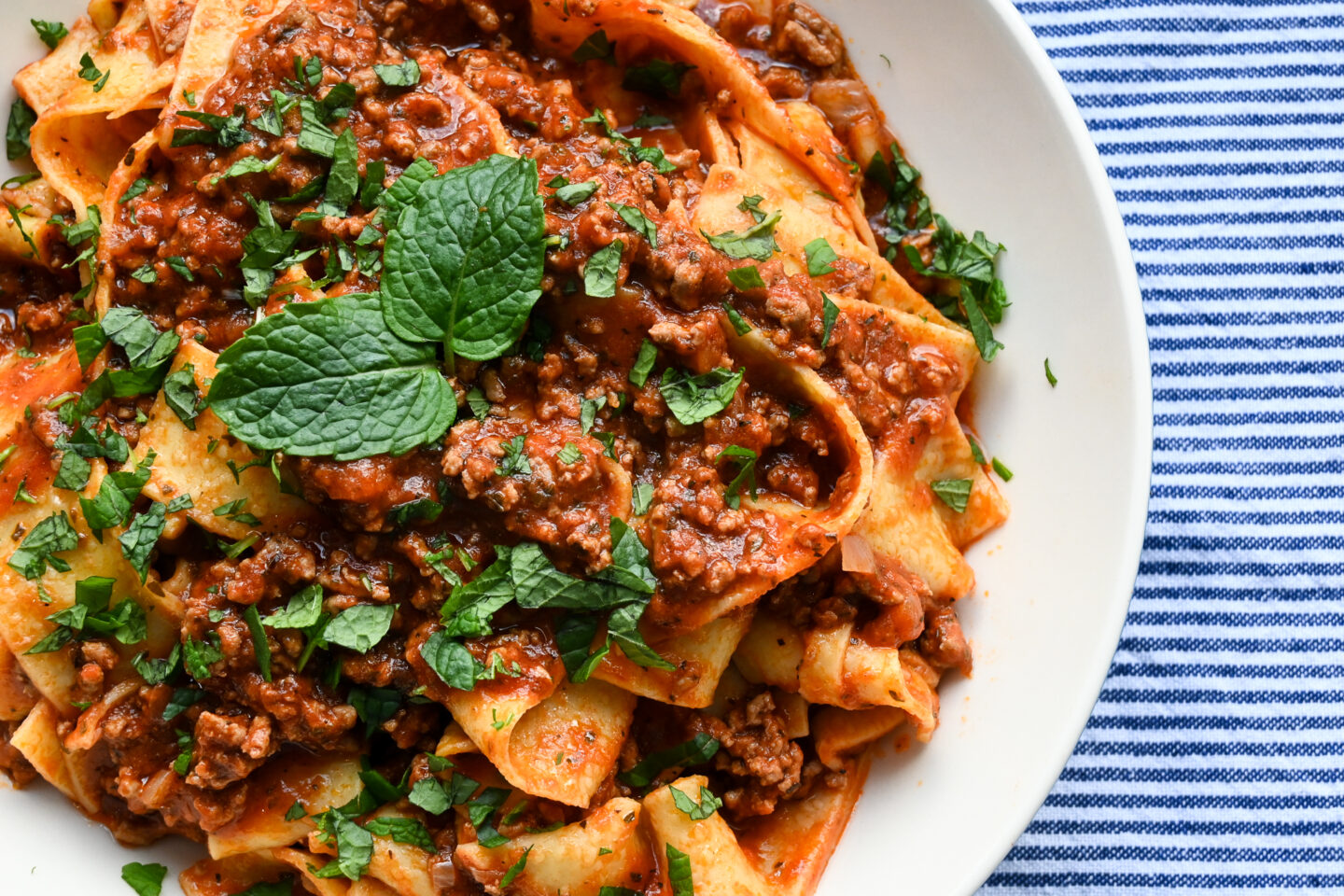 Pappardelle Pasta With Lamb Ragù garnished with mint leaves