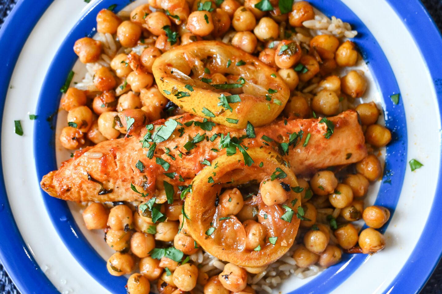 Harissa Salmon, Lemon & Chickpeas en Papillote with brown rice on a blue & white striped Cornishware plate