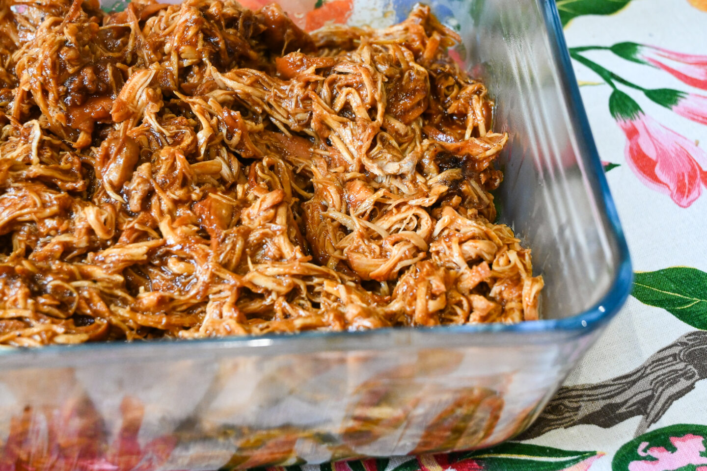 BBQ pulled chicken in a glasse pyrex casserole dish