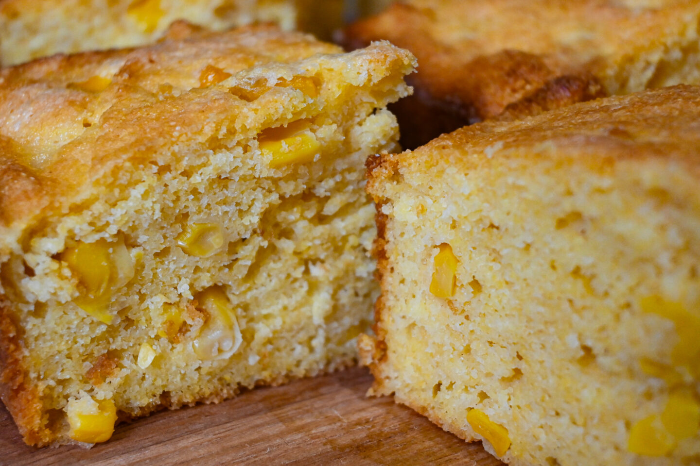 Closeup of cornbread squares with corn kernels inside