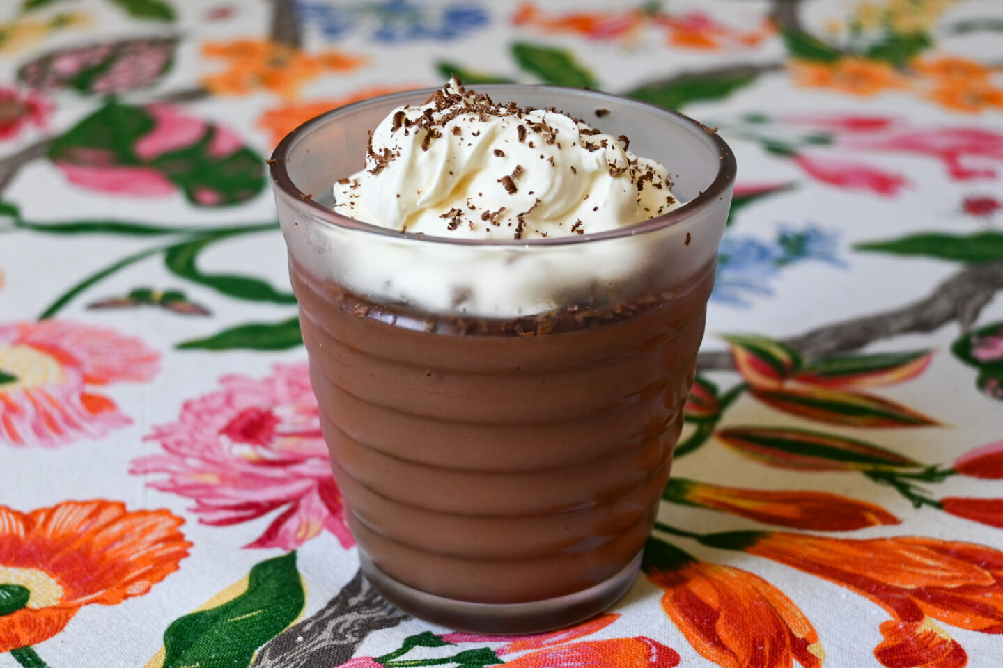 Chocolate Pudding in a small glass topped with whipped cream and chocolate shavings