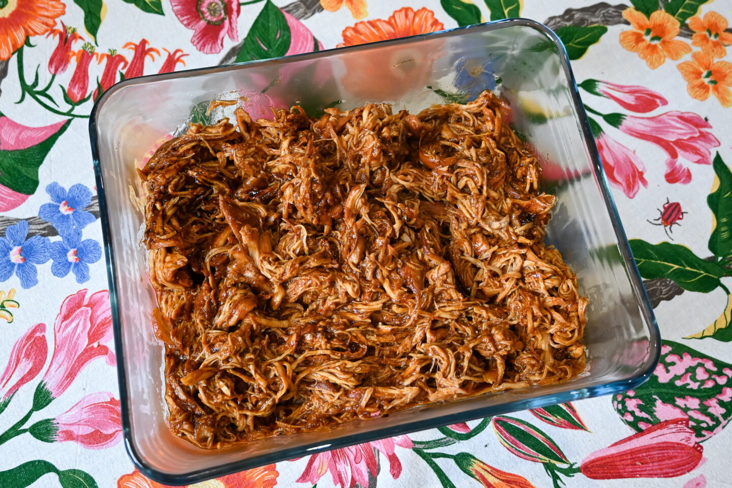 BBQ pulled chicken in a glasse pyrex casserole dish