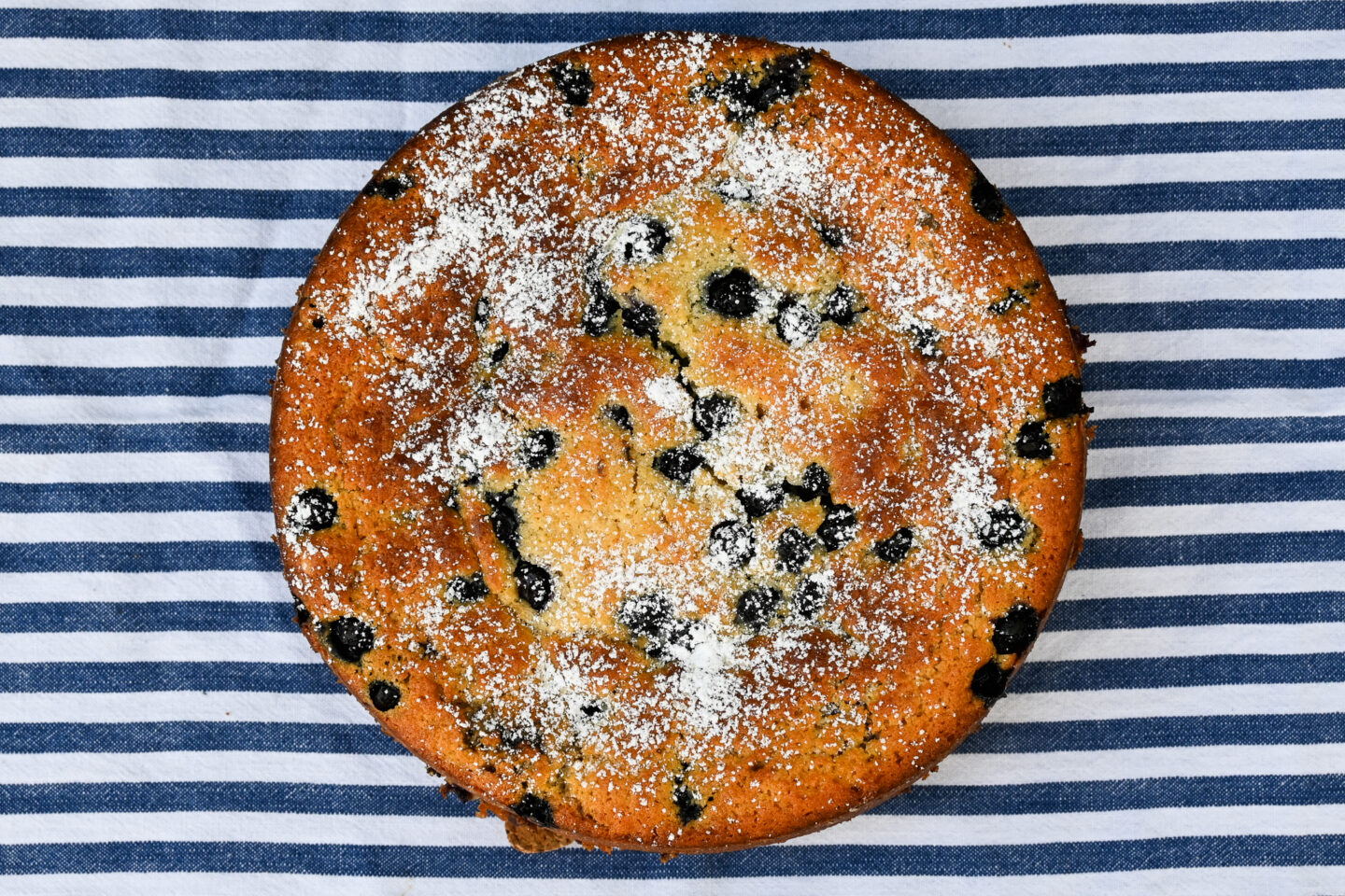 Blueberry Ricotta Cake on a blue & white striped background