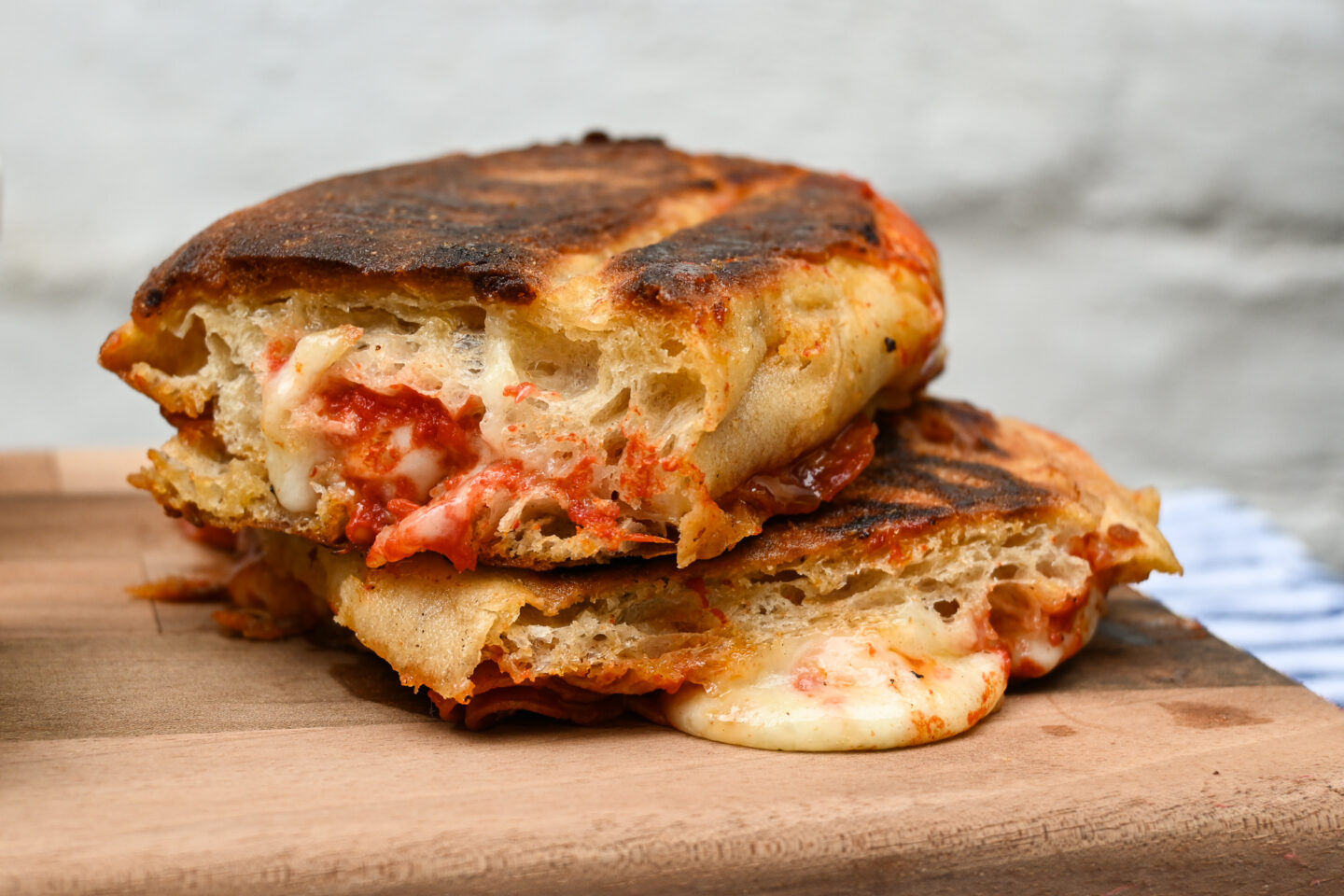 Close up of Pepperoni Pizza Panini on a wooden serving board