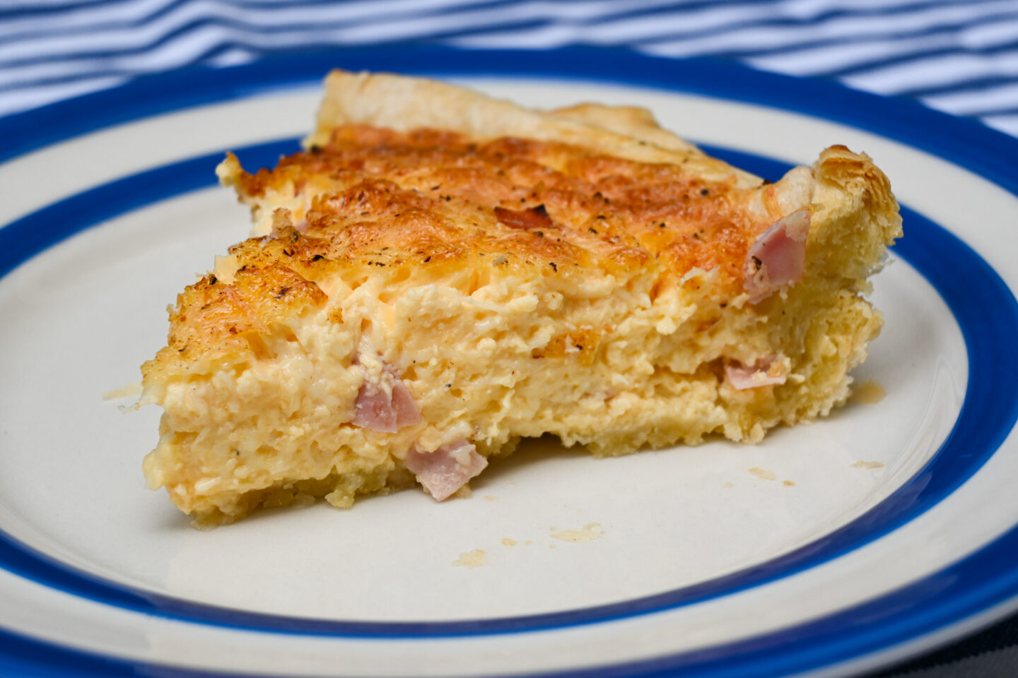 Closeup of inside of Puff Pastry Ham & Cheese Quiche slide from the side