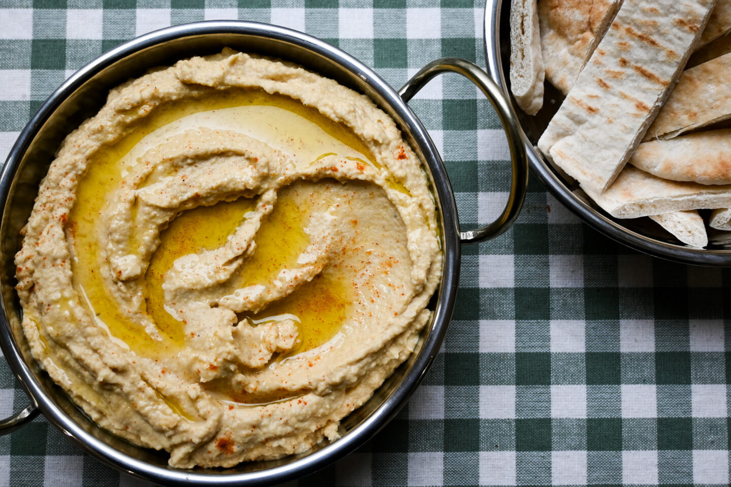 Roasted Garlic & Lemon Hummus drizzled with olive oil & sprinkled with a scant amount of Cayenne Pepper and pitta bread strips on the side.