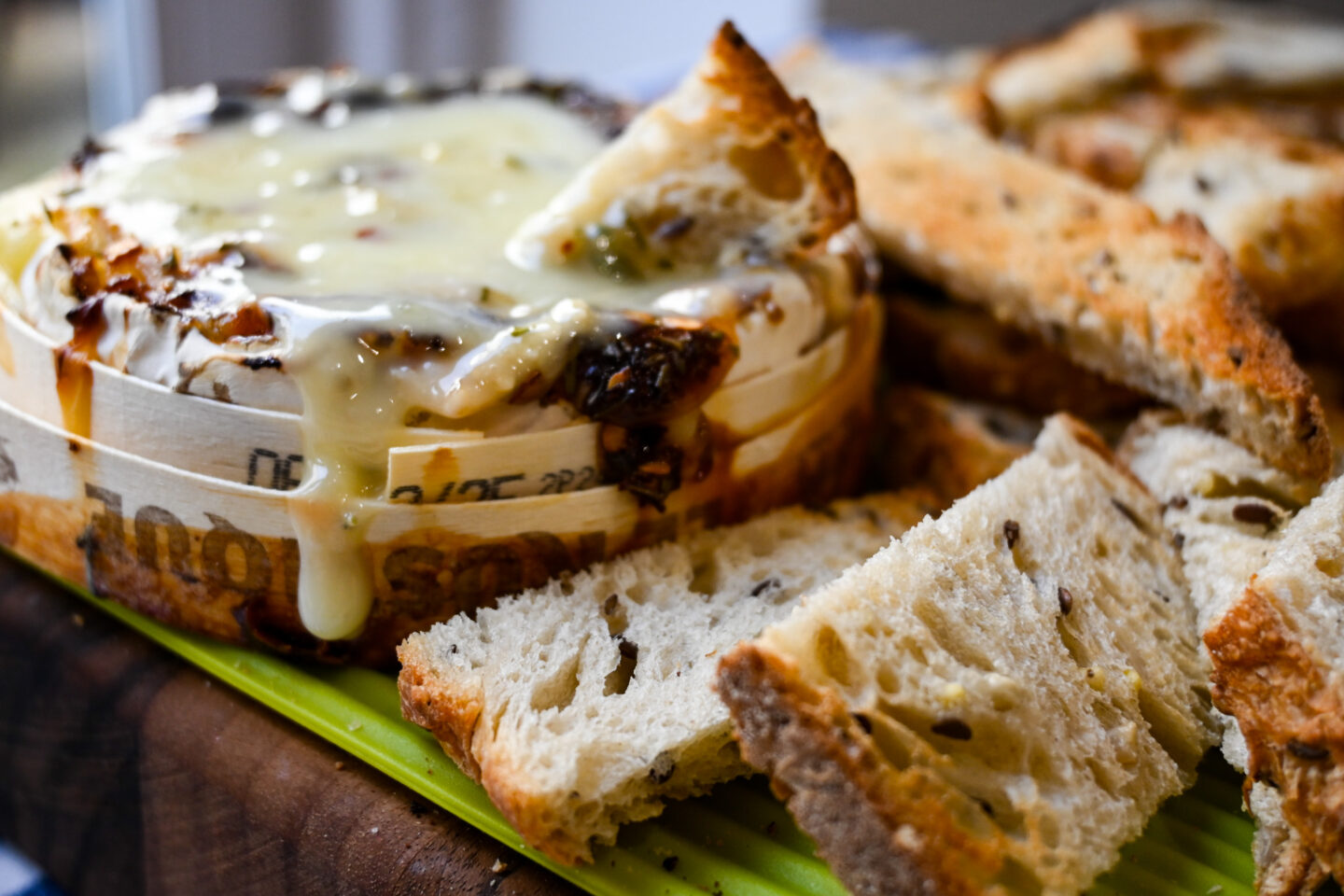 Oozing melted baked camembert with a piece of toasted bread dipped in and more bread on the side