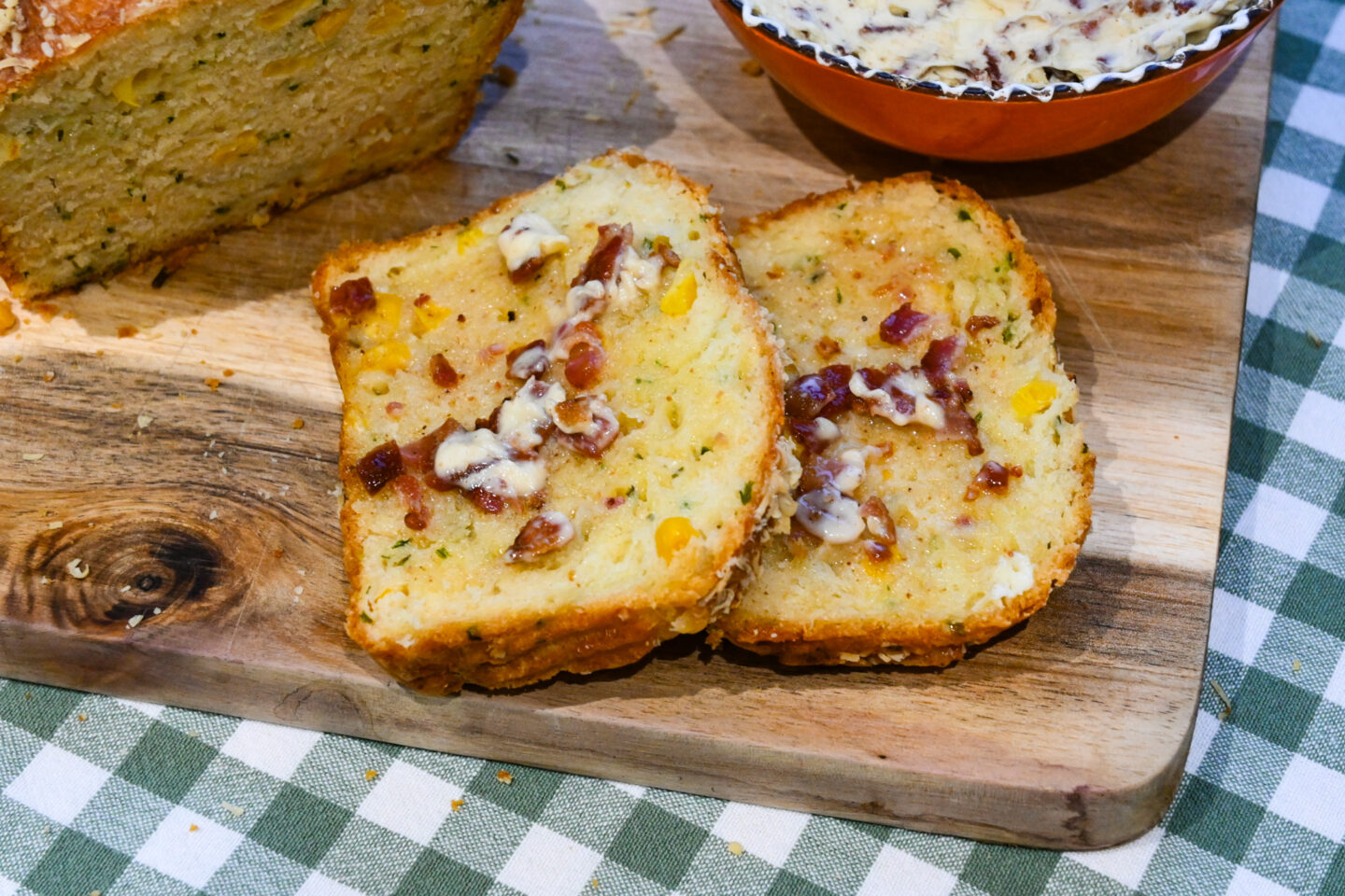 Close-up of bacon butter melting on hot slices of corny cheese bread