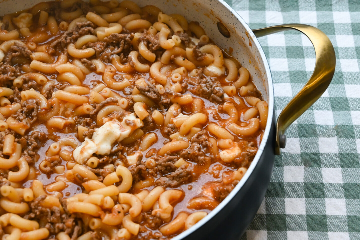 Pot of Cheesy Beef-a-Roni showing melted chunks of mozzarella cheese